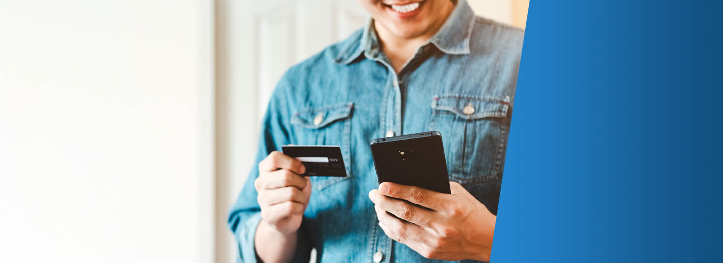 man holding credit card buying making a purchase online